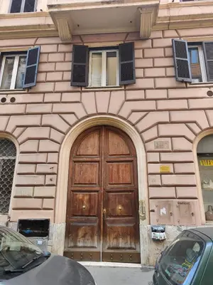 a building with a large wooden door on it at White King Rooms in Rome