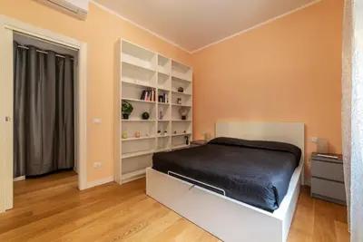 a bedroom with a bed and a book shelf at GuestHost - Roma Trastevere Vibes Apartment in Rome