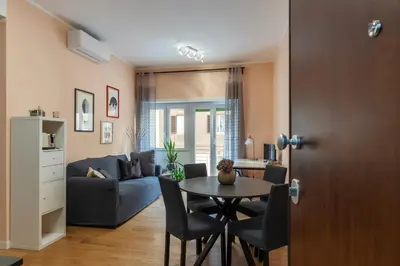 a living room with a table and a couch at GuestHost - Roma Trastevere Vibes Apartment in Rome