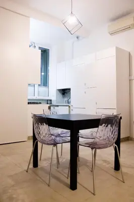 a black table and two chairs in a kitchen at Home Rent Mancini in Rome