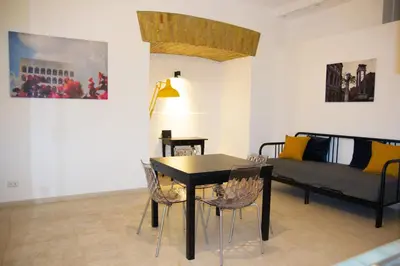 a living room with a table and chairs and a couch at Home Rent Mancini in Rome