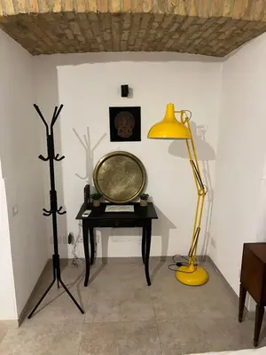 a room with a table and a lamp and a mirror at Home Rent Mancini in Rome