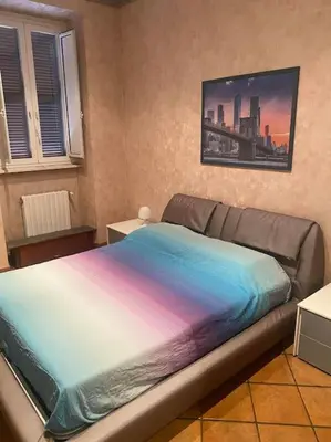 a bedroom with a bed with a colorful blanket at Allegra’s House Barberini in Rome