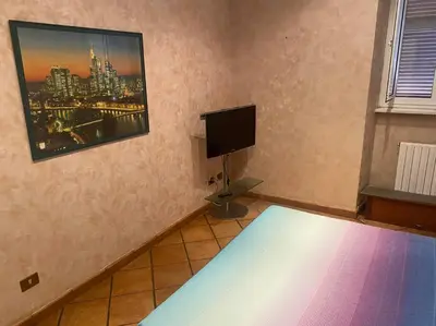a bedroom with a bed and a flat screen tv at Allegra’s House Barberini in Rome