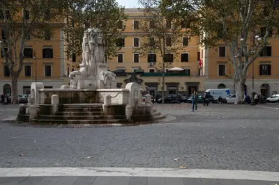 a fountain in the middle of a street with a building at Piazza Testaccio Home apt E1- Luminoso con vista piazza Testaccio in Rome