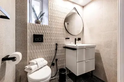 a bathroom with a toilet and a sink and a mirror at Piazza Testaccio Home apt E1- Luminoso con vista piazza Testaccio in Rome
