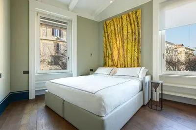 a bedroom with a large bed and two windows at Casa Loren con Terrazzo in Rome