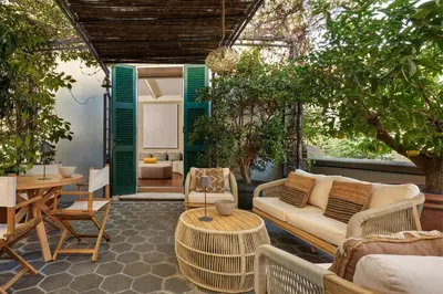 a patio with a couch and a table and trees at Casa Loren con Terrazzo in Rome