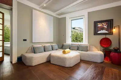 a living room with a couch and a large window at Casa Loren con Terrazzo in Rome
