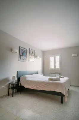 a bedroom with a large bed in a room at Romantic apartment [Metro A Ponte Lungo] in Rome