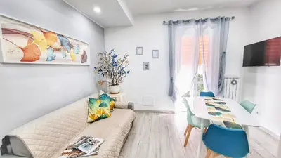 a living room with a couch and a table at FaMaCrì Home in Rome