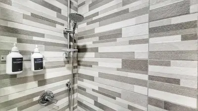 a bathroom with a shower with two bottles of soap at FaMaCrì Home in Rome
