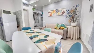 a kitchen and living room with a bed in a room at FaMaCrì Home in Rome