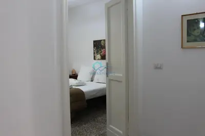 a door leading to a bedroom with a bed at Casa di Pera in Rome