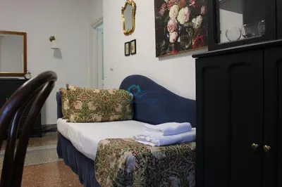 a room with a chair with towels on it at Casa di Pera in Rome
