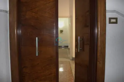 a wooden door in a room with a hallway at Casa di Pera in Rome