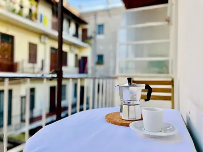 a coffee maker and a cup on a table on a balcony at GuestHost - The Design Pasta Apartment in Rome