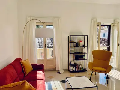 a living room with a red couch and a chair at GuestHost - The Design Pasta Apartment in Rome