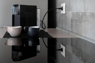 a table with two cups on top of it at LEMON SUITES APARTMENTS in Rome