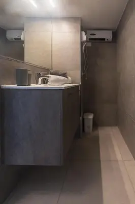 a bathroom with a sink and a mirror at LEMON SUITES APARTMENTS in Rome