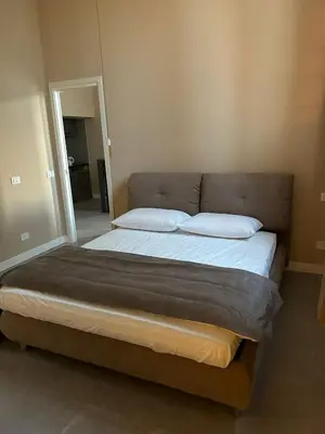 a large bed with two pillows in a bedroom at LEMON SUITES APARTMENTS in Rome