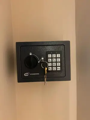 a remote control on a wall with a pair of keys at LEMON SUITES APARTMENTS in Rome