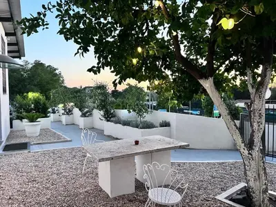 a table and chairs under a tree on a building at LEMON SUITES APARTMENTS in Rome
