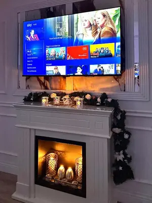 a television above a fireplace with a fire place at 6 AL TOP in Rome