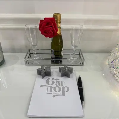 a table with a bottle of champagne and a red rose at 6 AL TOP in Rome
