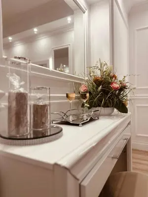 a white counter with two glasses of wine and flowers at 6 AL TOP in Rome