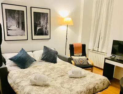 a living room with a bed and a chair at Piazza Testaccio Home appartamento E 2 Accogliente e Silenzioso in Rome