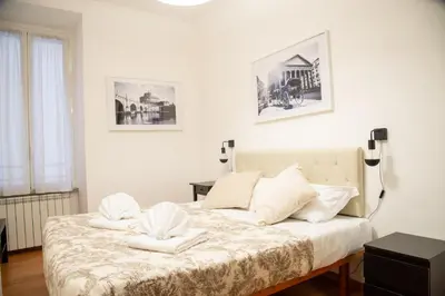 a bedroom with a bed with two white towels at Piazza Testaccio Home appartamento E 2 Accogliente e Silenzioso in Rome