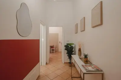 a hallway with a table and a hallway with a room at Boho Chic Apartment By Nosdom Properties in Rome