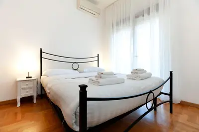 a bedroom with a bed with towels on it at CAVALLEGGERI HOUSE in Rome