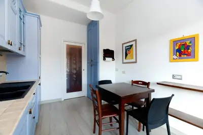 a kitchen and dining room with a table and chairs at CAVALLEGGERI HOUSE in Rome