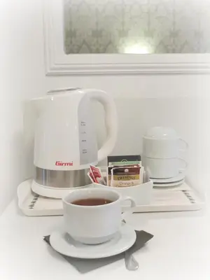 a coffee maker and a cup of coffee on a shelf at Le Suite dei Mercanti in Rome