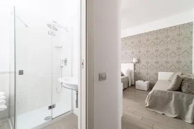 a bathroom with a shower and a sink in a room at Le Suite dei Mercanti in Rome