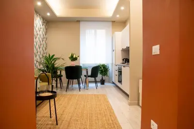 a kitchen and dining room with a table and chairs at Arezzo 38 in Rome