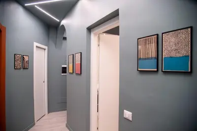 a hallway with several paintings on the walls at Arezzo 38 in Rome