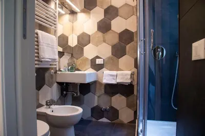 a bathroom with a sink and a toilet and a shower at Arezzo 38 in Rome