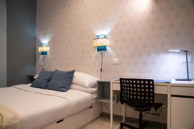 a bedroom with a bed and a desk and a chair at Arezzo 38 in Rome