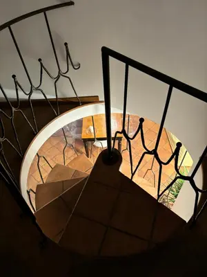a spiral staircase with a sign that reads vault at Boutique rooms trastevere in Rome