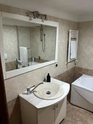 a bathroom with a sink and a mirror and a tub at Boutique rooms trastevere in Rome