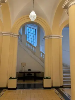 a staircase in a building with a table in the middle at Boutique rooms trastevere in Rome