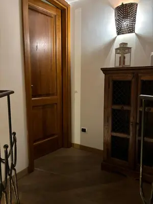 a room with a wooden door and a wooden cabinet at Boutique rooms trastevere in Rome