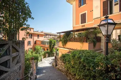a street with buildings and a street light next to a sidewalk at Vittoria in Trastevere Apartment in Rome
