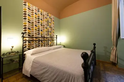 a bedroom with a bed with a wooden floor at Vaticana Ottaviani Roma in Rome