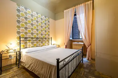 a bedroom with a large bed and a window at Vaticana Ottaviani Roma in Rome