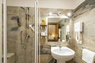a bathroom with a sink and a shower at Vaticana Ottaviani Roma in Rome