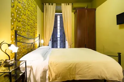a bedroom with a white bed and a window at Vaticana Ottaviani Roma in Rome